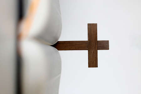 Open holy bible with wooden cross in the middle.の写真素材