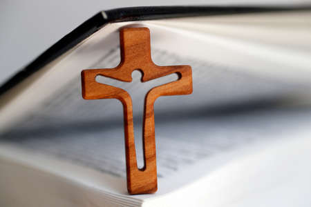 Small wooden crcifix with Holy bible. Faith and religion.の写真素材