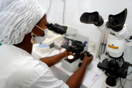 Biology in an African hospital. A laboratory technician testing blood samples Benin.のeditorial素材