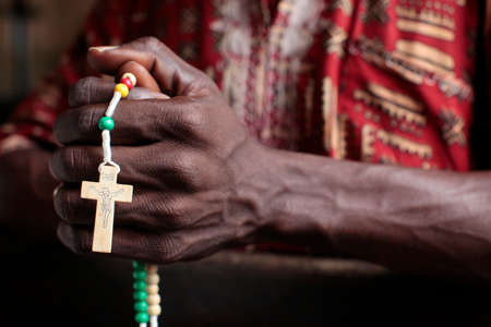 African man praying the rosary. Benign.の写真素材