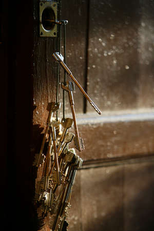 Keys on the door of a church. Italy.の写真素材