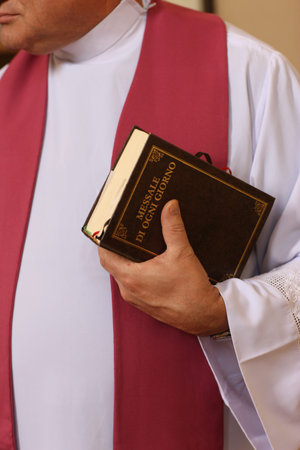 catholic mass. Priest with a Bible. Mali.