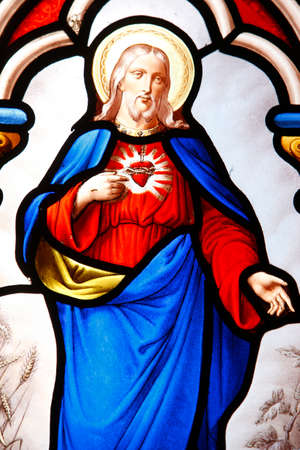 Jesus's sacred heart. Stained glass window. France.のeditorial素材
