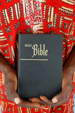 African man reading the bible. Togo.