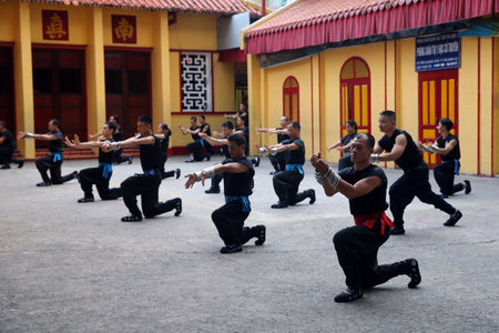 Men practicing martial arts in a buddhist temple. Ho chi Minh City. Vietnam.のeditorial素材