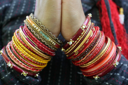 Tibetan dancer's bangles. Closeup on hands. France.