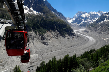 French Alps. Mont Blanc massif. The Mer De Glace glacier which has thinned 150 meters since 1820, and retreated by 2300 meters. Gondola lift. Chamonix. France.のeditorial素材