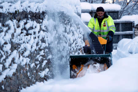 Man cleaning the snow with a snowblower. Saint-Nicolas de Veroce. France.のeditorial素材