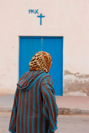 Veiled woman walking in the street. Morocco.