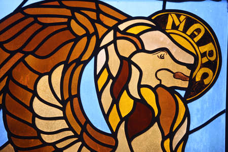 Stained glass depicting evangelist Saint-Mark symbolized by a lion. France.のeditorial素材