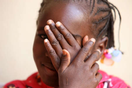 African girl hiding the face in her hands Mali.のeditorial素材