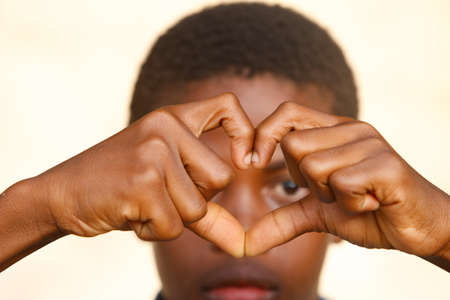 African boy making a heart shape. Portrait. Togo.のeditorial素材