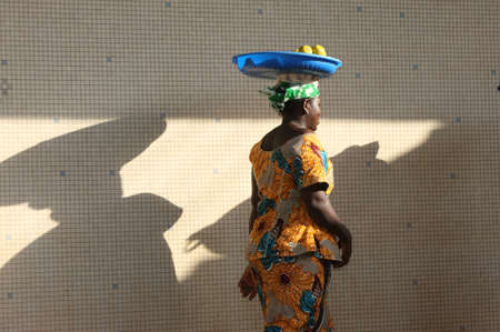 Woman with fruits and her shadow on the wall. mali.のeditorial素材