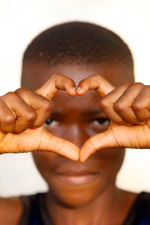 African boy making a heart shape. Portrait. Togo.のeditorial素材