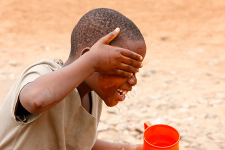 Boy washing his face. Togo.