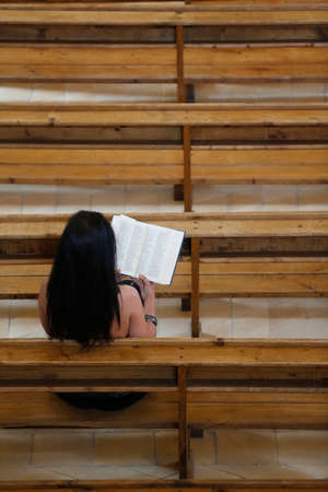 Woman reading the bible in a church. France.のeditorial素材