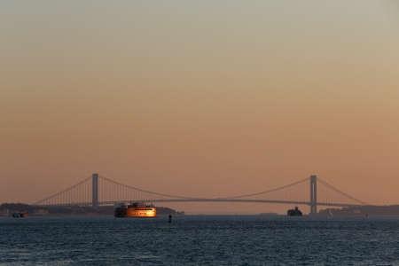 Ferry and Verrazano-Narrows Bridge Spanning Upper New York Bay. United states of America.の写真素材