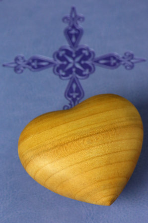 Carved wooen heart on a Holy Bible. France.の写真素材