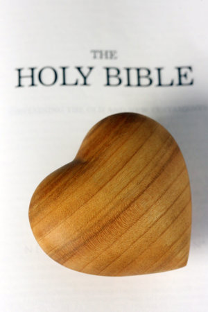 Carved wooden heart on a Holy Bible. France.の写真素材