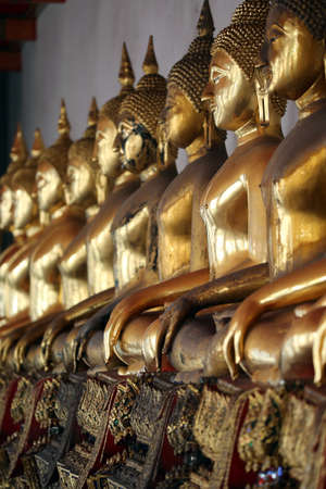 Seated Golden Buddha statues in a row at Wat Pho (Temple Of The Reclining Buddha), Bangkok.のeditorial素材