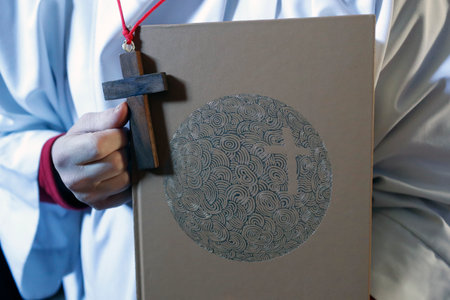 Saint-Jacques church. Catholic mass. Altar boy with lectionary. Sallanches. France.のeditorial素材