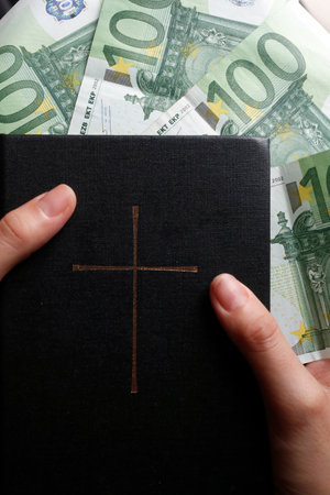 Money and religion. Holy bible and euros.のeditorial素材
