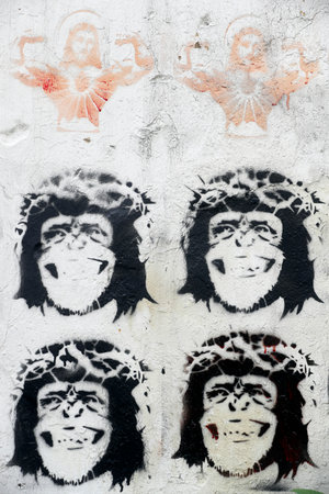 Stenciled image of Jesus Christ and monkeys wearing a crown of thorns, on a wall. Caricature. Ha Noi. Vietnam.のeditorial素材