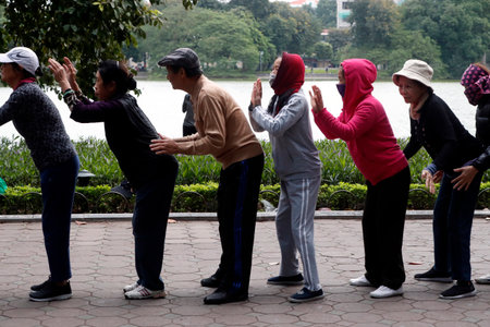 Morning exercise. Group massage at Hoan Kiem Lake. Ha Noi. Vietnam.のeditorial素材