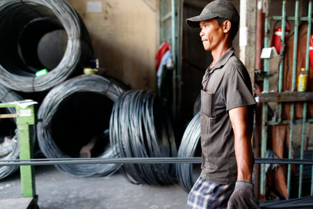 Steel rebar for concrete reinforcing construction building industry. Construction worker. Cai Be. Vietnam.のeditorial素材