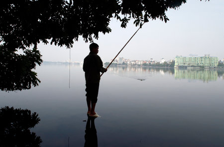 Man fishing on Ho Tay lake. Ha Noi. Vietnam.のeditorial素材