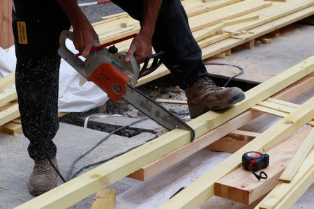 House under construction. Carpenter at work.のeditorial素材