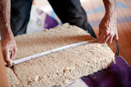 House under construction. Construction worker installing insulation.のeditorial素材