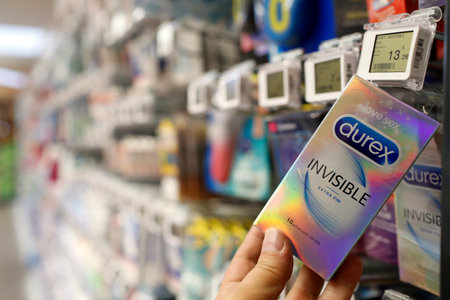 Stalls in row at supermarket. Parapharmacy products. Condoms. Man shopping. France.のeditorial素材
