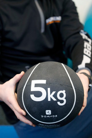 Health club. Man exercising with medicine ball. France.のeditorial素材