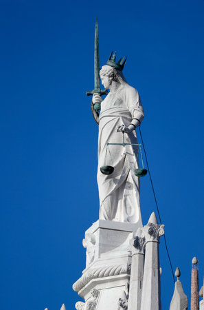Palazzo Ducale (Doges Palace). Statue of Justice with her traditional symbols of sword and scales. Venice. Italy.のeditorial素材