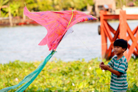 Young boy flying his kite. Cai Be. Vietnam.のeditorial素材