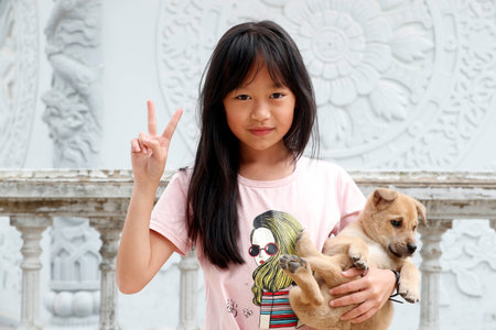 Young girl with her dog in arms. Dalat. Vietnam.のeditorial素材