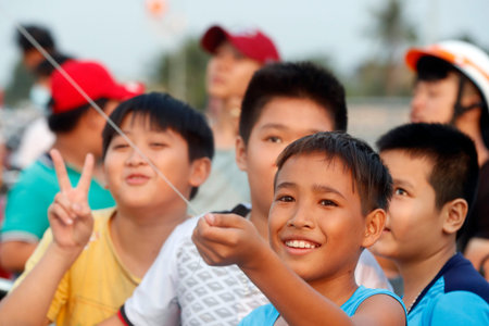 Vietnamese children flying kites on Cai Be bridge. Vietnam.のeditorial素材