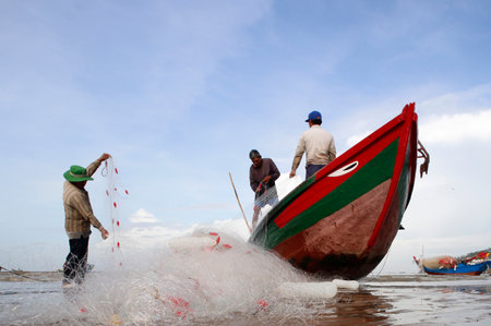 South China Sea. Fishermen repairing fishing nets. Vung Tau. Vietnam.のeditorial素材
