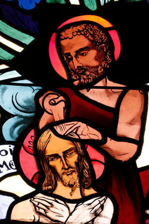 Saint Joseph des Fins church. The Baptism of Jesus Christ by John the Baptist. Stained glass window. Annecy. France.のeditorial素材