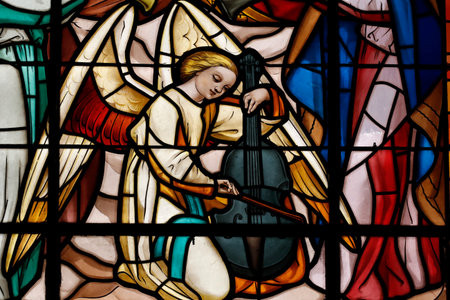 Notre Dame de Liesse church. Angel with violin. Stained glass window. Annecy. France.のeditorial素材