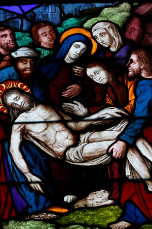 St Peter church. Passion of Christ. Jesus is placed in the tomb. Stained glass window. Dreux. France.のeditorial素材
