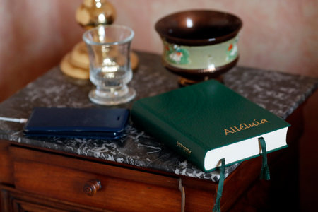 Alleluia, a Protestant Praise and Worship Songbook, on the bedside table in the interior of bedroom. France.のeditorial素材