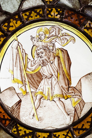 Hospices de Beaune museum. Stained glass window. Saint Christopher carrying the Christ child. 16th century. France.のeditorial素材