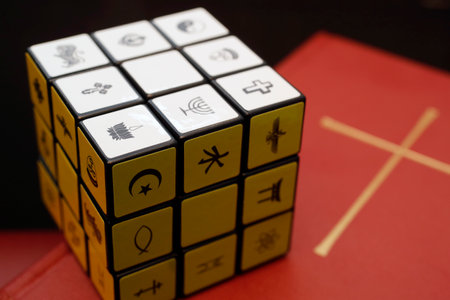 Bible and Rubik's cube with religious symbols. Interreligious and interfaith dialog concept.のeditorial素材