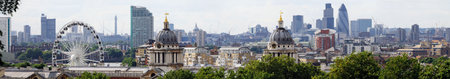 London skyline from Greenwich, with the twin domes of the Old Royal Naval College and the Greenwich Wheel in the foreground.  In the distance are such landmarks as the former Post Office Tower, Tower Bridge, St Paul's Cathedral, Lloyds of London, Tower 42の写真素材