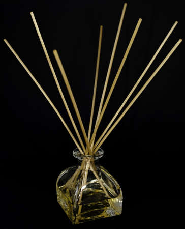 clear glass bottle of perfume with reeds or wicks to dispense the scent by capillary action -- an air freshenerの写真素材