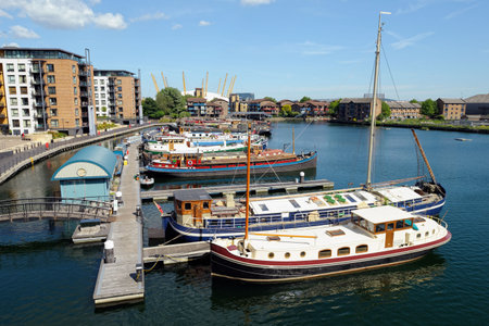 View from Trafalgar Way, Canary Wharf, London, England, UK, looking across Blackwall Basin marina towards Preston's Road with the O2 Arena in the backgroundの写真素材