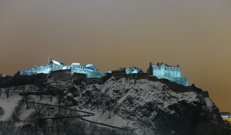 Edinburgh Castle, Scotland, UK, illuminated at night in the winter snowの写真素材