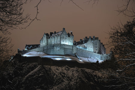 Edinburgh Castle, Scotland, UK, illuminated at night in the winter snowの写真素材